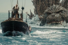 Godzilla swims after a ship.