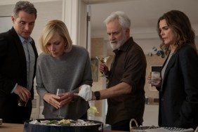 A group of people stand over a table in The Diplomat Season 3.